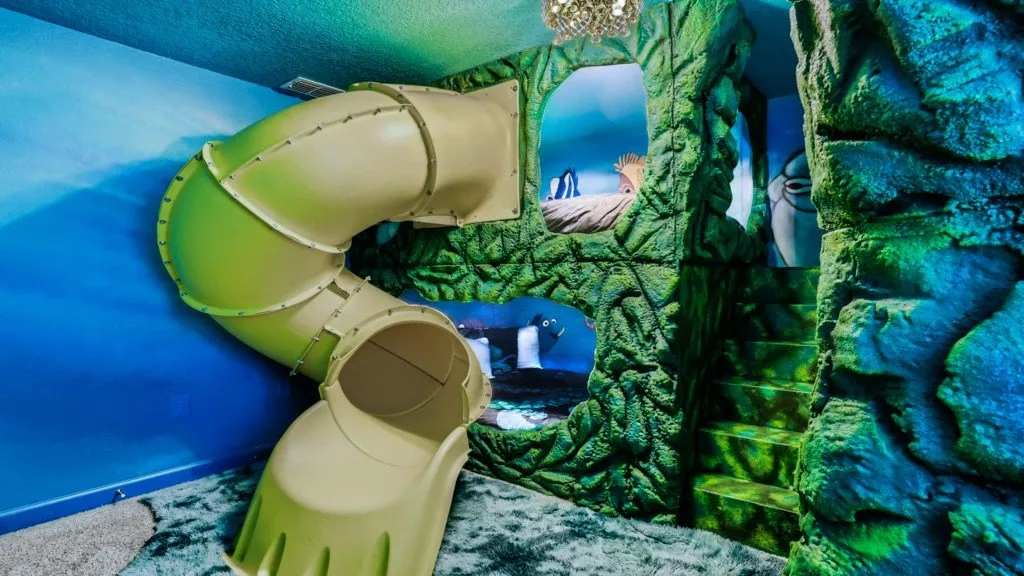 Ocean Nemo themed room with indoor tube slide and rock cave walls
