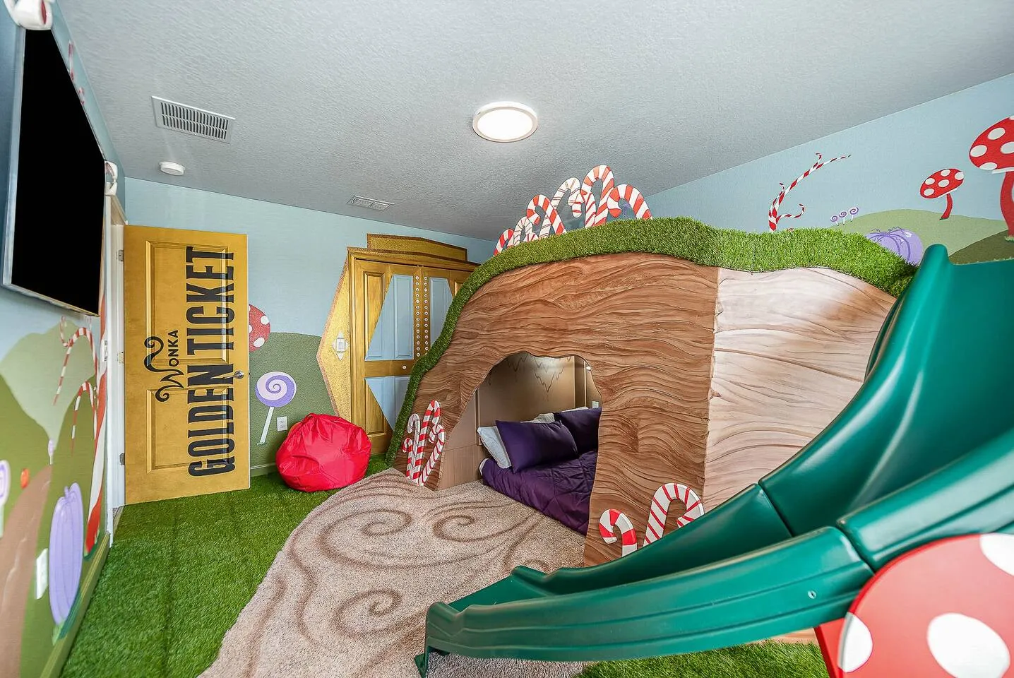 Willy Wonka Candy Land themed bedroom with golden ticket door and indoor slide